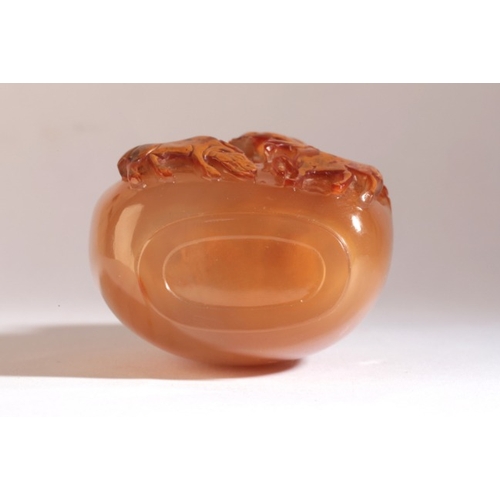 56 - A CHINESE AGATE SNUFF BOTTLE

18th/19th century, the honey coloured body of bulbous form with rams c... 