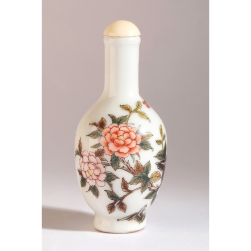 57 - A CHINESE PORCELAIN SNUFF BOTTLE

bearing a Qianlong four character mark to base, painted with birds... 