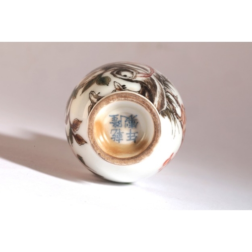 57 - A CHINESE PORCELAIN SNUFF BOTTLE

bearing a Qianlong four character mark to base, painted with birds... 