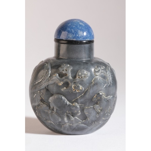 62 - A CHINESE JADE SNUFF BOTTLE

19th century, the 'black' nephrite carved in Suzhou style with three sa... 