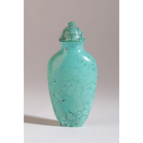 68 - A CHINESE TURQUOISE SNUFF BOTTLE

19th century, of small proportion and flattened form with two mask... 