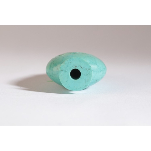 68 - A CHINESE TURQUOISE SNUFF BOTTLE

19th century, of small proportion and flattened form with two mask... 