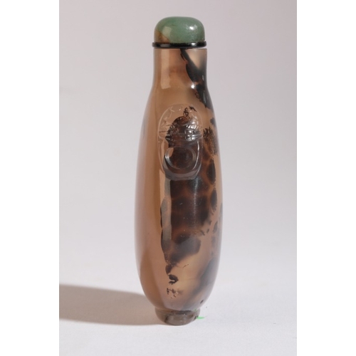 69 - A CHINESE AGATE SNUFF BOTTLE

18th/19th century, with natural dark inclusions to one side giving the... 