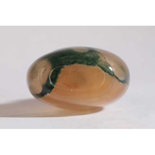 81 - A CHINESE AGATE SNUFF BOTTLE

19th century, the natural green inclusions forming a scene of a tree a... 