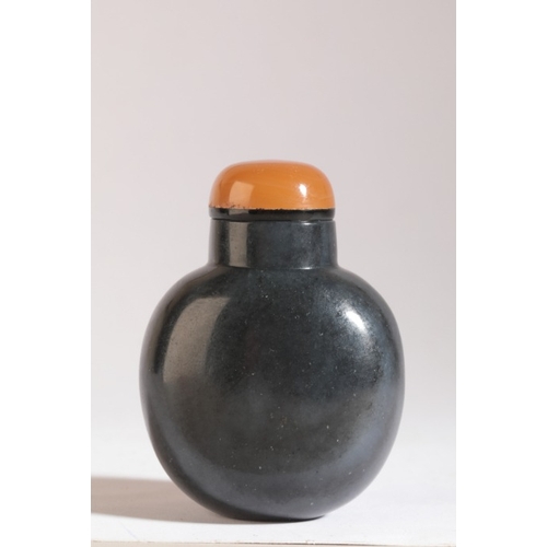 90 - A CHINESE JADE SNUFF BOTTLE

19th century, the 'black' nephrite body carved to the front with an eag... 