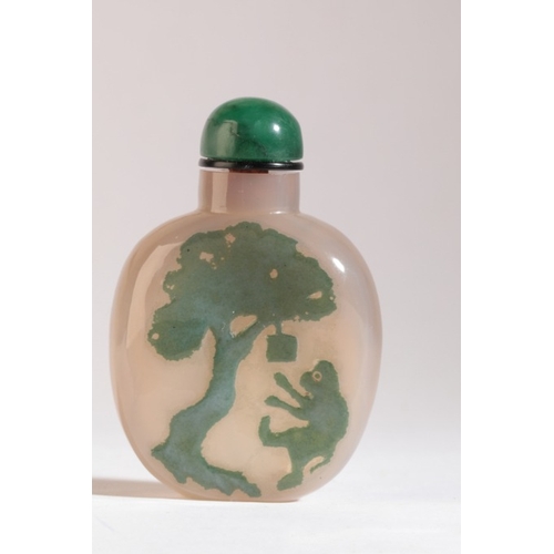 94 - A CHINESE AGATE SNUFF BOTTLE

19th century, the green silhouette inclusion carved with a monkey swin... 