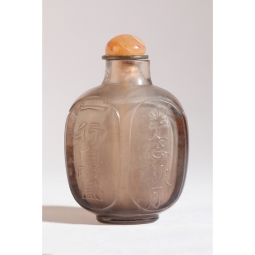 95 - A CHINESE CRYSTAL SNUFF BOTTLE

19th century, one side carved into the brown/orange skin with panels... 