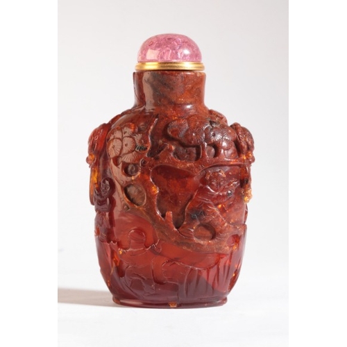 96 - A CHINESE AMBER SNUFF BOTTLE

likely 18th/19th century, carved to the front with sages amongst pine ... 