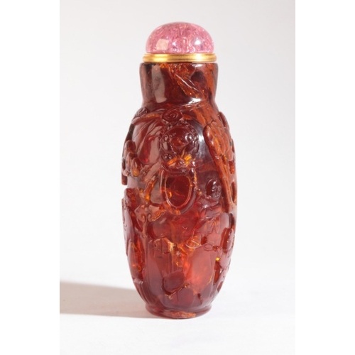 96 - A CHINESE AMBER SNUFF BOTTLE

likely 18th/19th century, carved to the front with sages amongst pine ... 