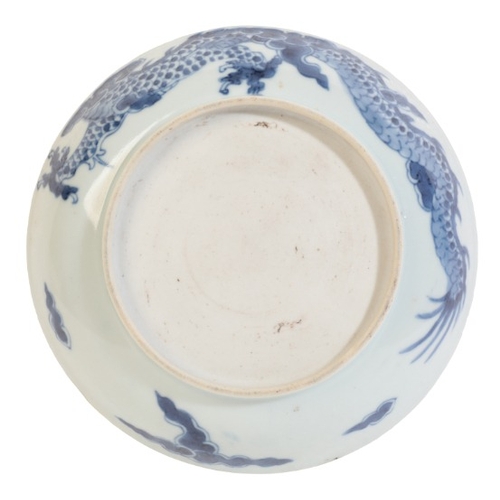 252 - A CHINESE PORCELAIN BLUE AND WHITE 'DRAGON' DISH

18th century, decorated with a dragon chasing a pe... 