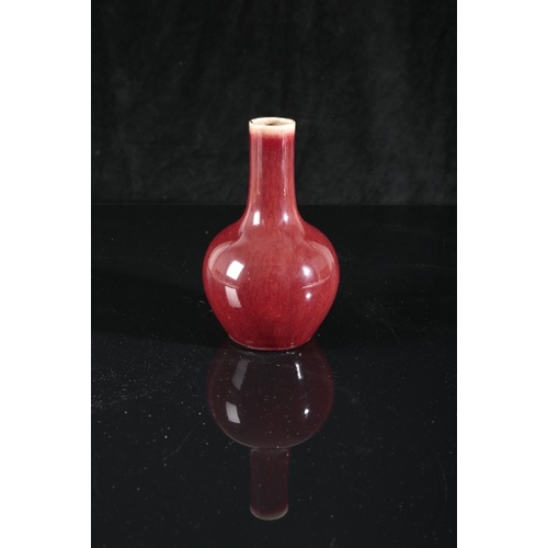 303 - A CHINESE PORCELAIN FLAMBE GLAZED BOTTLE VASE

probably Qianlong period, the rich red glaze lightly ... 