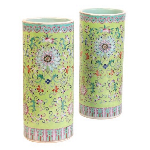 326 - A PAIR OF CHINESE PORCELAIN GREEN GROUND FAMILLE ROSE SLEEVE VASES

20th century, decorated with lot... 