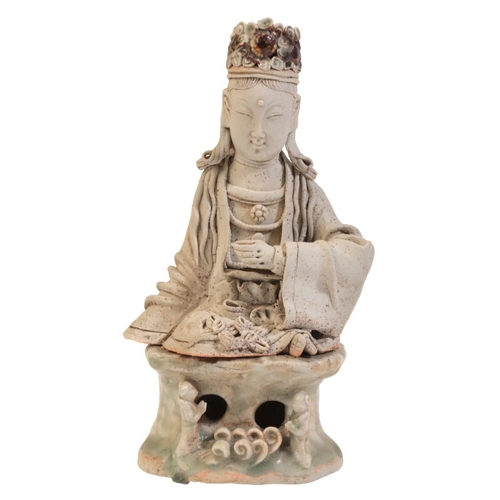 328 - A CHINESE HUTIAN WARE FIGURE OF GUANYIN

Yuan Dynasty or later, seated on a naturistic qingbai glaze... 