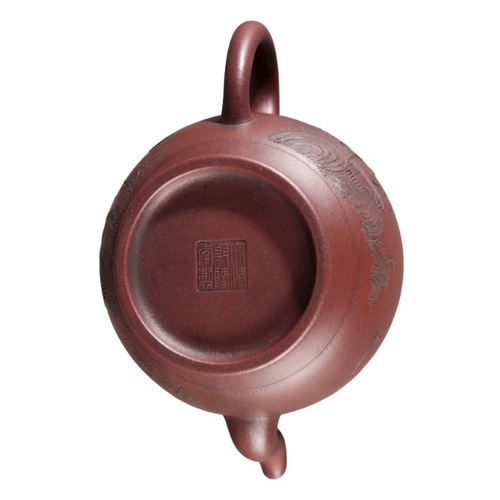 364 - A CHINESE YIXING TEAPOT

bearing a six character Qianlong seal mark to the base, of bulbous shape, d... 