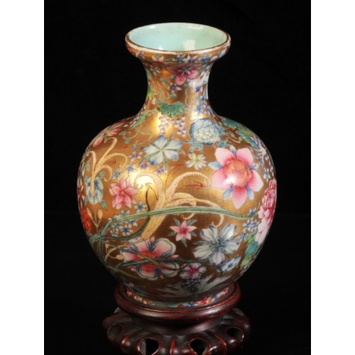 375 - A CHINESE PORCELAIN 'HUNDRED FLOWERS' FAMILLE ROSE VASE

bearing a six character Qianlong seal mark ... 