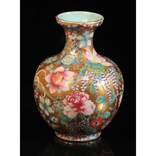 375 - A CHINESE PORCELAIN 'HUNDRED FLOWERS' FAMILLE ROSE VASE

bearing a six character Qianlong seal mark ... 