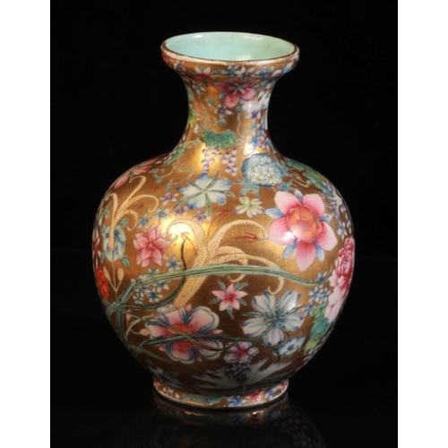 375 - A CHINESE PORCELAIN 'HUNDRED FLOWERS' FAMILLE ROSE VASE

bearing a six character Qianlong seal mark ... 