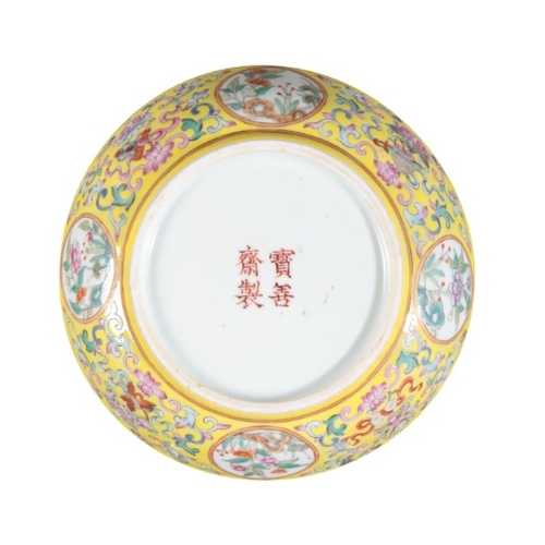 383 - A CHINESE PORCELAIN YELLOW GROUND FAMILLE ROSE SAUCER

bearing a four character mark to the base, Qi... 