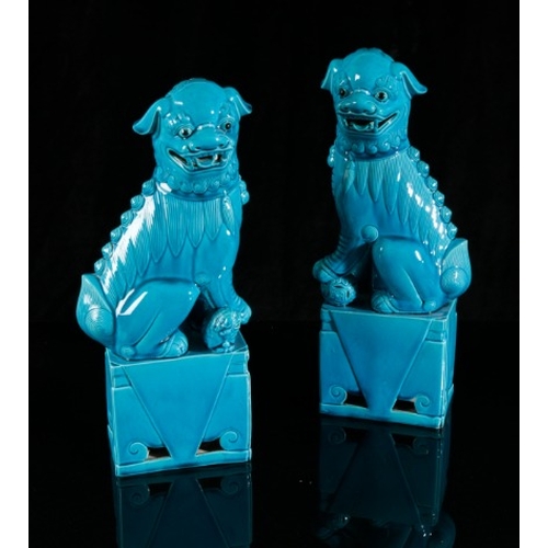 406 - A PAIR OF CHINESE TURQUOISE GLAZED DOGS OF FO

20th century, figured seated on plinth bases, 40cm hi... 