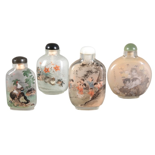 424 - A GROUP OF FOUR CHINESE INSIDE PAINTED GLASS SNUFF BOTTLES

20th century, three bearing inscriptions... 