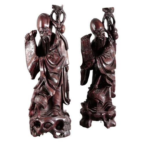 442 - A PAIR OF CHINESE CARVED WOOD FIGURES OF SHOULAO

20th century, figured holding a staff and an open ... 