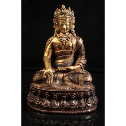 482 - A GILT BRONZE FIGURE OF SEATED BUDDHA

probably 18th century or after, modelled in padmasana on a do... 