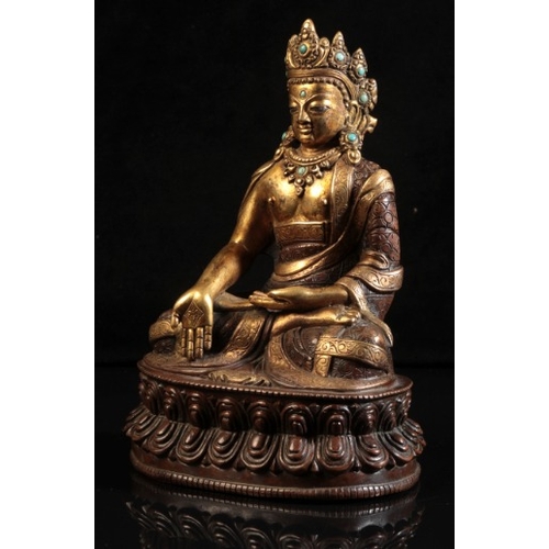 482 - A GILT BRONZE FIGURE OF SEATED BUDDHA

probably 18th century or after, modelled in padmasana on a do... 