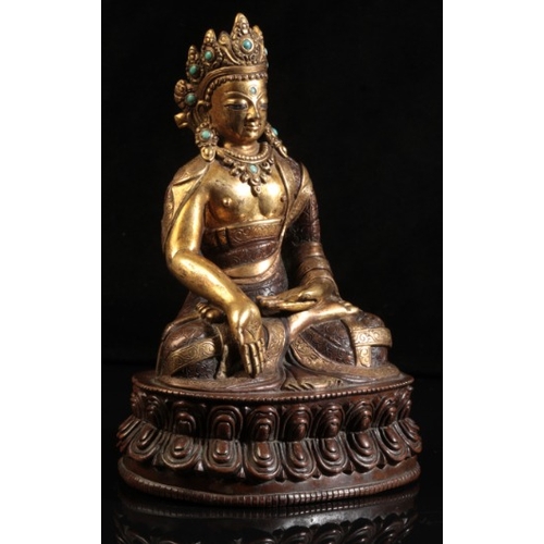 482 - A GILT BRONZE FIGURE OF SEATED BUDDHA

probably 18th century or after, modelled in padmasana on a do... 