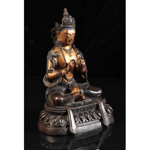 483 - A SINO-TIBETAN PARCEL GILT BRONZE FIGURE OF SEATED BUDDHA

bearing a six character Qianlong mark to ... 