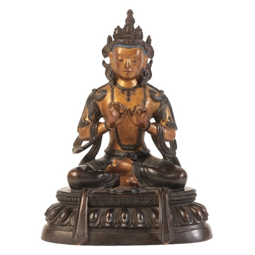 483 - A SINO-TIBETAN PARCEL GILT BRONZE FIGURE OF SEATED BUDDHA

bearing a six character Qianlong mark to ... 