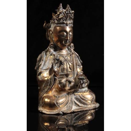 490 - A GILT BRONZE FIGURE OF SEATED GUANYIN

Ming dynasty or later, seated in dhyanasana, the right hand ... 