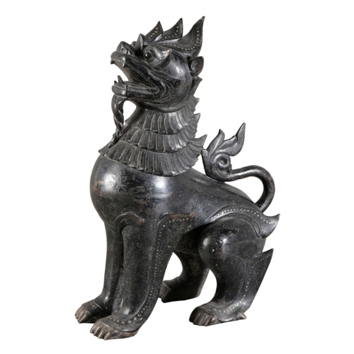 493 - A SOUTH EAST ASIAN BRONZE TEMPLE OR GUARDIAN DOG

20th century, inlaid with coloured stones, 46cm hi... 