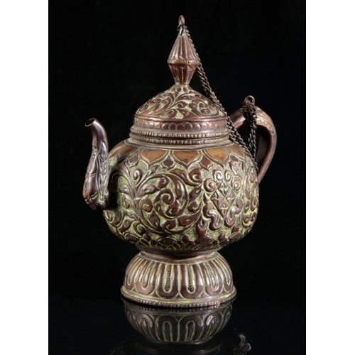 499 - A TIBETAN BRONZE EWER

late 19th/early 20th century, embossed with abundant floral decoration to the... 