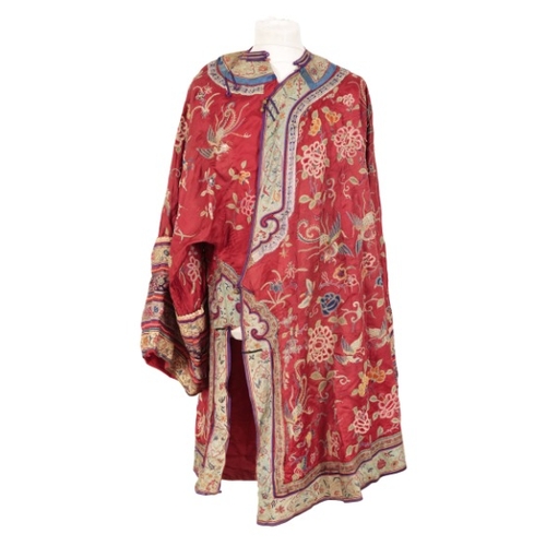 506 - A CHINESE RED SILK ROBE

late Qing dynasty, woven with phoenix in flight, insects and an abundance o... 