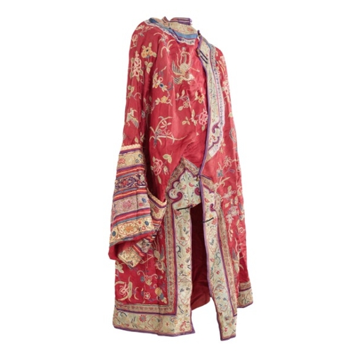 506 - A CHINESE RED SILK ROBE

late Qing dynasty, woven with phoenix in flight, insects and an abundance o... 