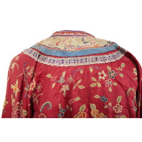 506 - A CHINESE RED SILK ROBE

late Qing dynasty, woven with phoenix in flight, insects and an abundance o... 