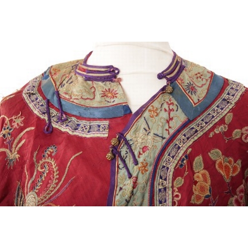 506 - A CHINESE RED SILK ROBE

late Qing dynasty, woven with phoenix in flight, insects and an abundance o... 