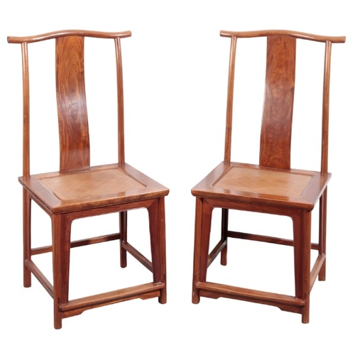 551 - A PAIR OF CHINESE YOKE BACK CHAIRS

20th century, with shaped back splats over caned seats, on turne... 