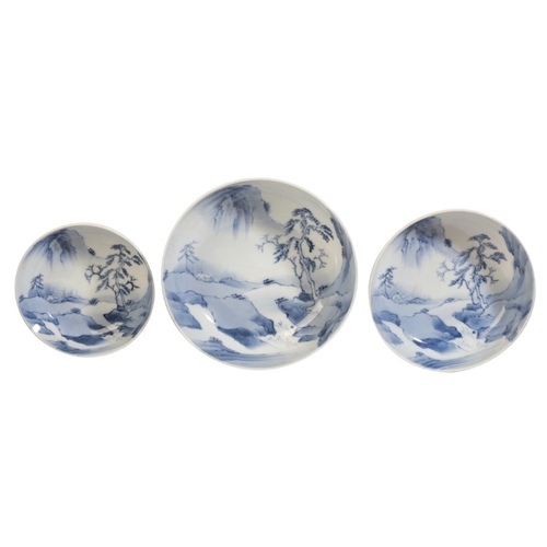 561 - A GRADUATED SET OF THREE JAPANESE PORCELAIN BLUE AND WHITE BOWLS

20th century, all decorated with l... 