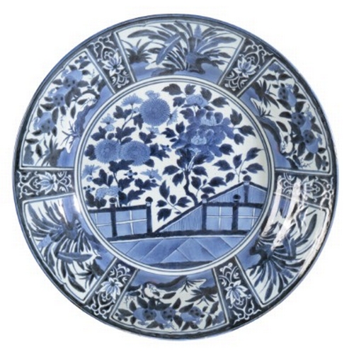 564 - A LARGE JAPANESE BLUE AND WHITE KRAAK CHARGER

Edo period, 17th century, decorated with chrysanthemu... 