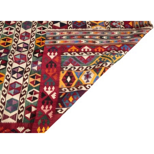 13 - A SOUTH WEST PERSIAN QASHGAI KILIM

woven in colours with lines of geometric motifs and scrolls, on ... 