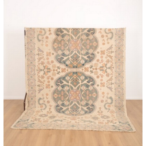 206 - A 'PORTUGUESE' FLAT STITCH RUG

20th century, the light ground with two contrasting floral medallion... 