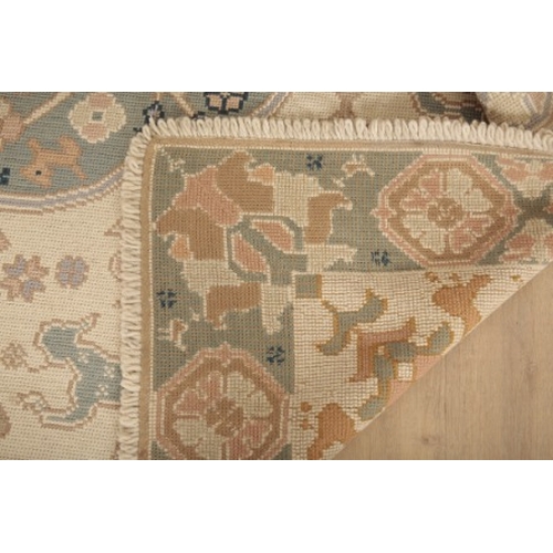 206 - A 'PORTUGUESE' FLAT STITCH RUG

20th century, the light ground with two contrasting floral medallion... 