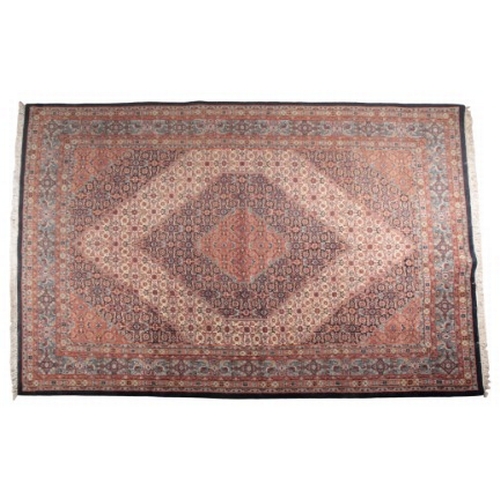 225 - AN INDO-PERSIAN CARPET OF SERABEND DESIGN

woven in muted colours with lozenge medallions and all ov... 