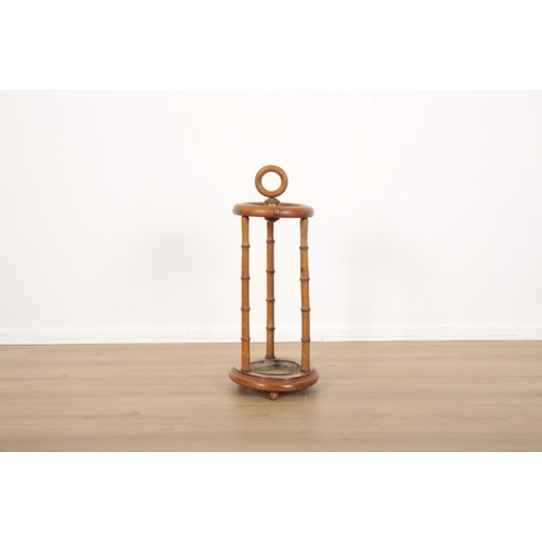 226 - A CIRCULAR STICK AND UMBRELLA STAND

late 19th century, a ring handle to the top, resting on three f... 