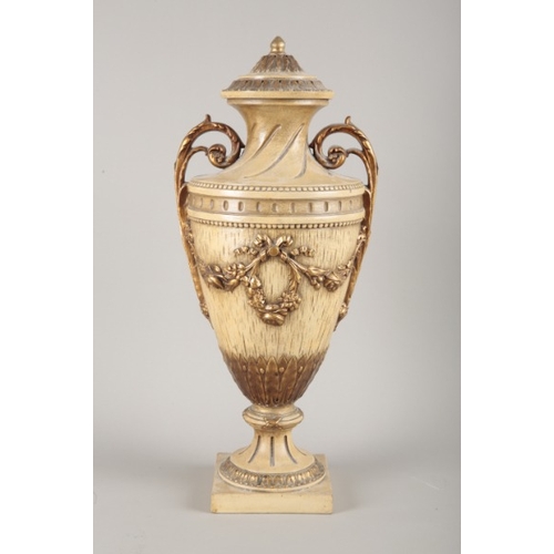 232 - A LARGE CERAMIC URN

of 18th Century style modelled with swags and gilded to highlights on a tan gro... 