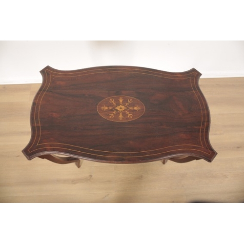 27 - AN EDWARDIAN ROSEWOOD AND MARQUETRY OCCASIONAL TABLE

the shaped top inlaid with a central floral pa... 