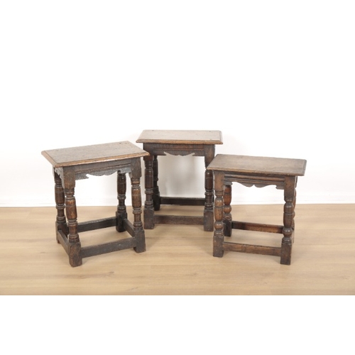 33 - THREE OAK STOOLS

17th century and later, including a matched pair with shaped carved aprons, all wi... 