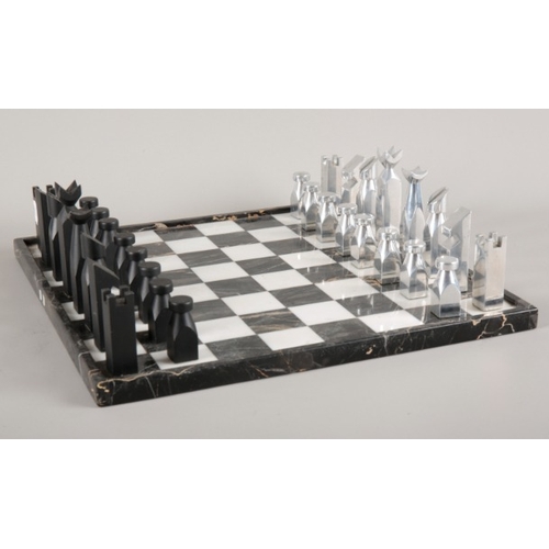 35 - A MARBLE CHESSBOARD

mid-century modern, with veined black and white marble chequered squares, 37.5c... 