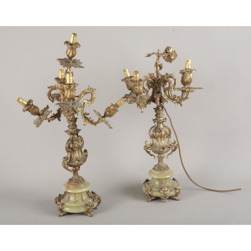 37 - A PAIR OF ORMOLU FOUR-BRANCHED CANDLEABRA IN ROCOCO STYLE

19th century and later, of scrolling foli... 